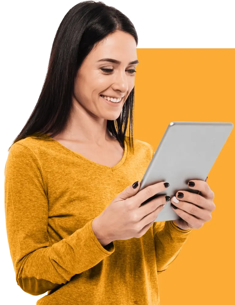 Happy woman standing using a tablet